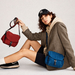 Botkier homepage hero image on model baxter crossbody in malbec and teal