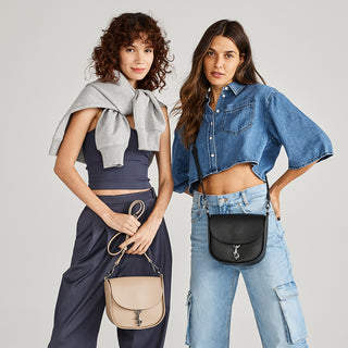 Botkier on model image featuring the trigger saddle in black and trigger saddle in latte