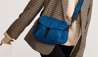 Botkier navigation feature image baxter nylon crossbody in teal