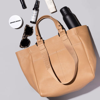 bedford tote in camel with sunglasses, water bottle, lip gloss coming out of bag